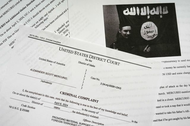 The criminal complaint against Alexander Scott Mercurio is photographed on Tuesday, April 9, 2024.  Mercurio, 18, is charged with attempting to provide material support to the Islamic State group after prosecutors said he planned to carry out an attack on a Coeur d'Alene church.  Mercurio was arrested Saturday, and the charges were unsealed in Idaho's U.S. District Court on Monday. (AP Photo/Jenny Kane)