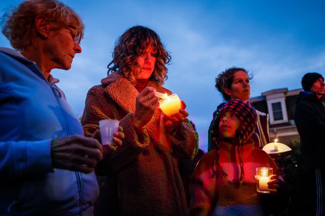 Hundreds spilled outside of the Basilica of Saints Peter and Paul while attending a vigil for the 18 people who were killed in Lewiston's mass shooting.
