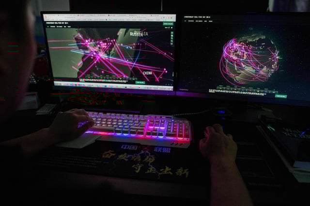 (FILES) In this file photo taken on August 04, 2020, Prince, a member of the hacking group Red Hacker Alliance who refused to give his real name, uses a website that monitors global cyberattacks on his computer at their office in Dongguan, China's southern Guangdong province. - As the number of online devices surges and super-fast 5G connections roll out, record numbers of companies are offering up to seven-figure rewards to ethical hackers who can successfully attack their cybersecurity systems. (Photo by NICOLAS ASFOURI / AFP) (Photo by NICOLAS ASFOURI/AFP via Getty Images)