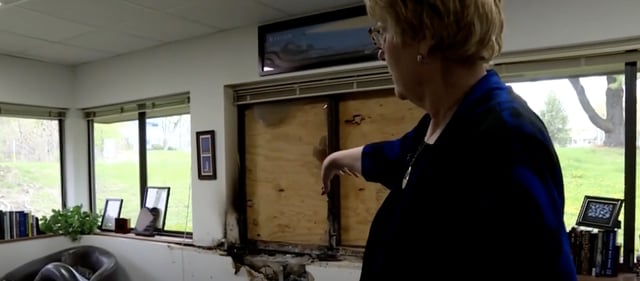Julaine Appling of Wisconsin Family Action points to office damage of firebombing on the organisation's Madison headquarters.
