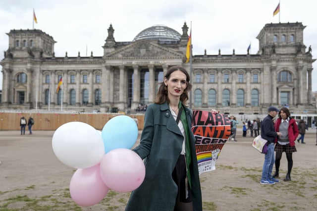 A demonstrator protests demanding a law to protect the rights of the transgender community outside of the parliament Bundestag building in Berlin, on April 12, 2024. 