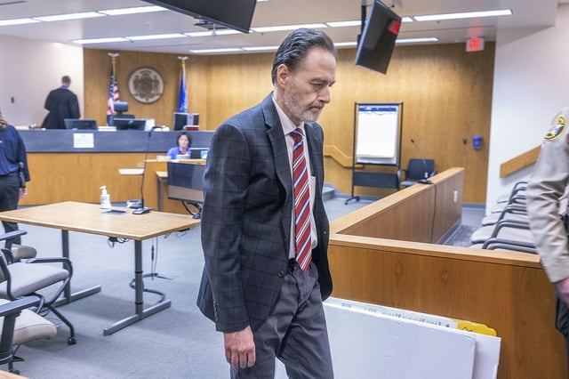 Nicolae Miu makes his way out of the courtroom after the guilty verdict at the St. Croix County District Court in Hudson, Wis., on Thursday, April 11, 2024. Miu, a 54-year-old Prior Lake man, has been convicted in the slaying of a 17-year-old high school student and stabbing of four other people who were tubing on a western Wisconsin river. (Elizabeth Flores/Star Tribune via AP)