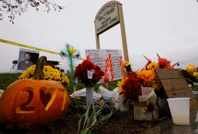 A makeshift memorial grows outside of Schemengees Bar & Grille one of two locations where a mass shooting killed 18 people.