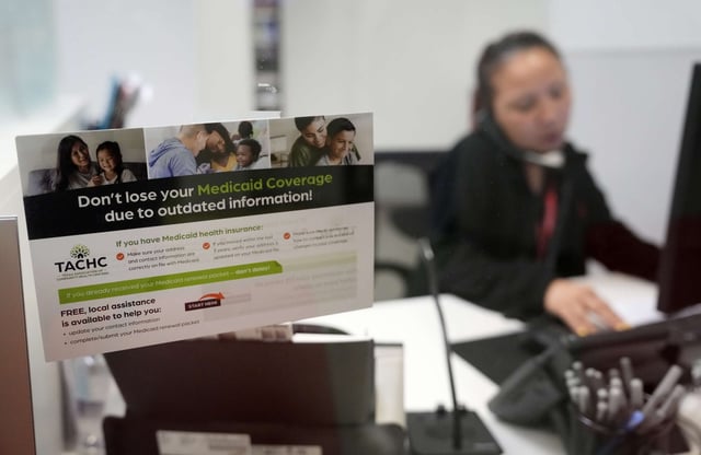 A reminder about Medicaid coverage is displayed as Trina Le, eligibility supervisor team lead, works at Hope Clinic on May 30, 2023, in Houston, Texas.