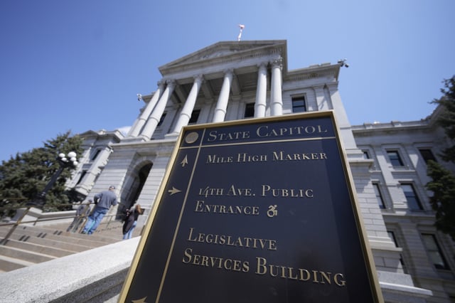 Visitors stand on the west steps of the Colorado Capitol, April 23, 2023, in Denver. Colorado's Democratic-controlled House on Sunday, April 14, 2024, passed a bill that would ban the sale and transfer of semiautomatic firearms, a major step for the legislation after roughly the same bill was swiftly killed by Democrats last year. (AP Photo/David Zalubowski, File)