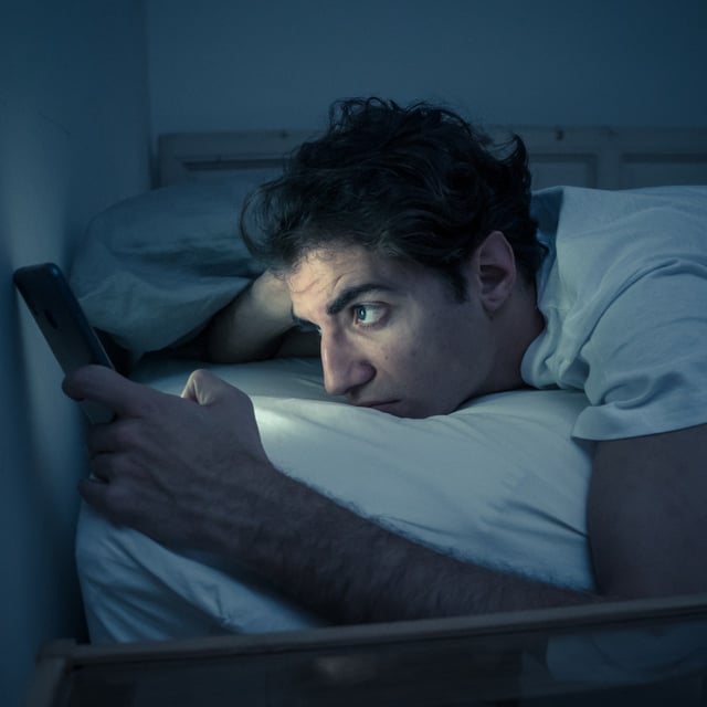 A stock photo shows a woman sleeping. Younger people get less sleep than older people, research suggests.