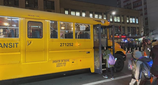Migrant children seen boarding a school bus outside the Row Hotel in Midtown Manhattan on Jan. 9, 2024.