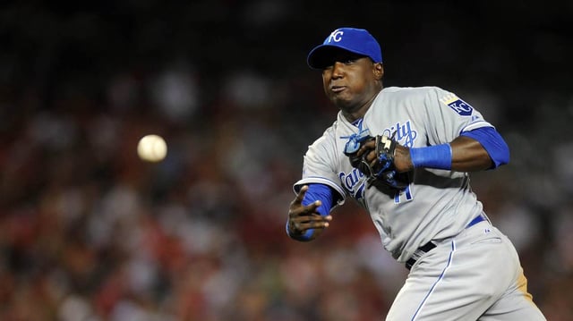 Jul 23, 2012; Anaheim, CA, USA; Kansas City Royals second baseman Yuniesky Betancourt (11) throws to first against the Los Angeles Angels during the fifth inning at Angel Stadium of Anaheim. Mandatory Credit: Kelvin Kuo-USA TODAY Sports
