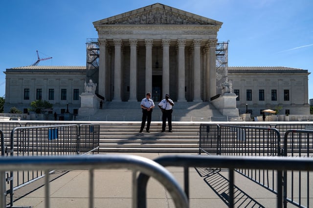 Supreme Court Police officers stand on the steps of the Supreme Court on April 16, in Washington, DC.