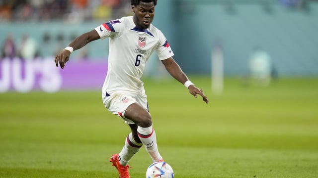 FILE - Yunus Musah of the United States dribbles the ball during their World Cup soccer match against the Netherlands, at the Khalifa International Stadium in Doha, Qatar, Saturday, Dec. 3, 2022. Musah is following United States teammate Christian Pulisic to American-owned AC Milan. Musah, who was born in New York but grew up in Italy and England, signed a five-year contract with the Rossoneri on Friday, Aug. 4, 2023 following a transfer from Valencia. (AP Photo/Ashley Landis, file)