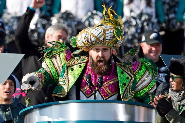 FILE âÃÃ¬ In this Feb. 8, 2018, file photo, Philadelphia Eagles center Jason Kelce speaks at the conclusion of the NFL team's Super Bowl victory parade in front of the Philadelphia Museum of Art in Philadelphia. When Kelce and his girlfriend Kylie McDevitt tied the knot Saturday, April 14, 2018, Kelce wore a tan, three-piece suit,  a toned-down look compared to the bright green, genie-like Mummers getup he donned for the parade. (AP Photo/Alex Brandon, File)