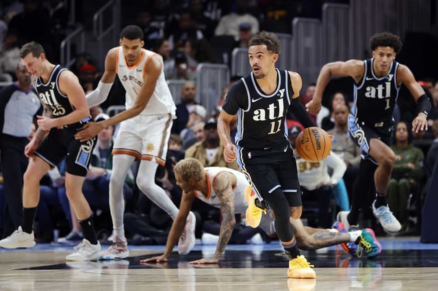 ATLANTA, GEORGIA - JANUARY 15: Trae Young #11 of the Atlanta Hawks drives against the San Antonio Spurs during the first half at State Farm Arena on January 15, 2024 in Atlanta, Georgia. NOTE TO USER: User expressly acknowledges and agrees that, by downloading and or using this photograph, User is consenting to the terms and conditions of the Getty Images License Agreement.