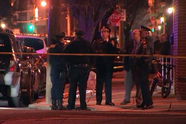 Police investigate a crime scene in South Philadelphia on March 1, 2022.