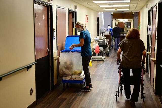 Staff Christy Tye, left, is house keeping at Good Samaritan Society nursing home in Loveland, Colorado on Tuesday, March 8, 2022.