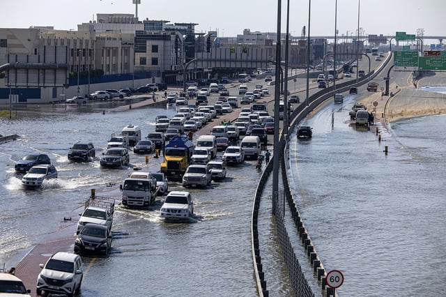 Vehicles attempt to navigate standing floodwater in Dubai, United Arab Emirates, Thursday, April 18.
