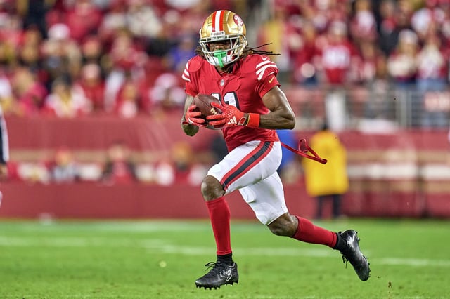 Brandon Aiyuk of the San Francisco 49ers runs with the football in action during a game between the San Francisco 49ers and the Baltimore Ravens at Levi's Stadium on Dec. 25, 2023, in Santa Clara, Calif.
