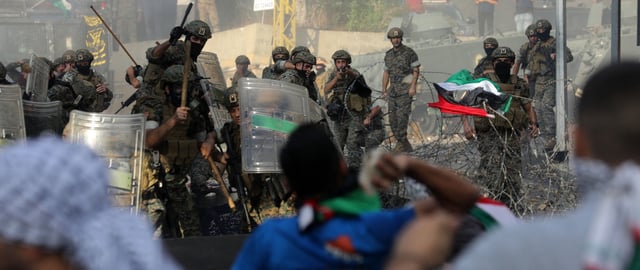 TOPSHOT - Protesters clash with Lebanese security forces outside the US Embassy in Awkar east of Beirut, during a demonstration in solidarity with the Palestinians of the Gaza Strip, on October 18, 2023. Thousands rallied across the Arab and Muslim world on October 18 to protest the deaths of hundreds of people in a strike on a Gaza hospital that they blame on Israel, despite its denials. (Photo by Ibrahim AMRO / AFP) (Photo by IBRAHIM AMRO/AFP via Getty Images)
