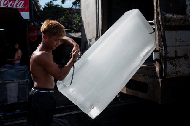 A worker unloads an ice block at a public market in Manila on another hot day in the Philippines earlier this month. Photo: Reuters