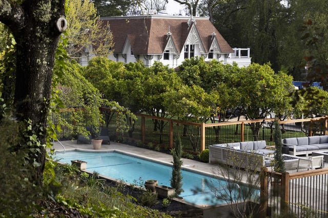 The Carriage House and pool are seen through layers of greenery at The Madrona in Healdsburg, Calif. Tuesday, March 29, 2022.