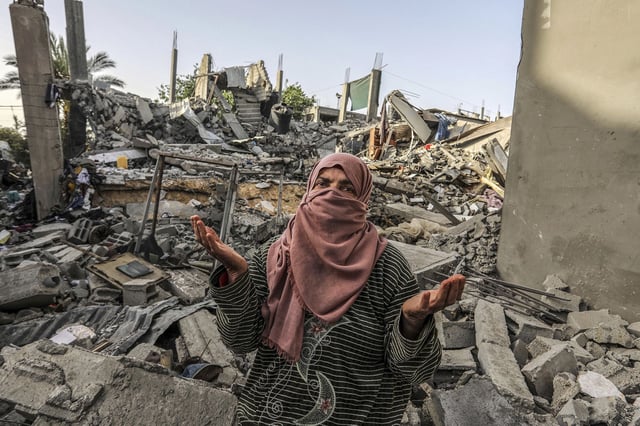 A Palestinian woman inspects a house that was destroyed by an Israeli bombing in Rafah, in the south of the Gaza Strip, on Wednesday.