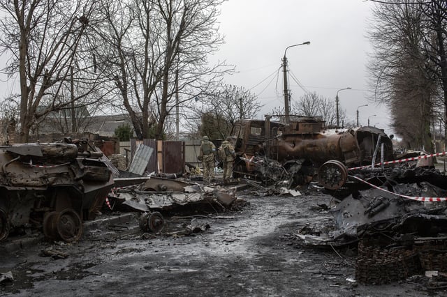 Ukrainian servicemen inspect the wreckage of Russian military vehicles in the town of Bucha, on the outskirts of Kyiv, after the Ukrainian army secured the area following the withdrawal of the Russian army from the Kyiv region on previous days, Bucha, Ukraine, April 8th, 2022.