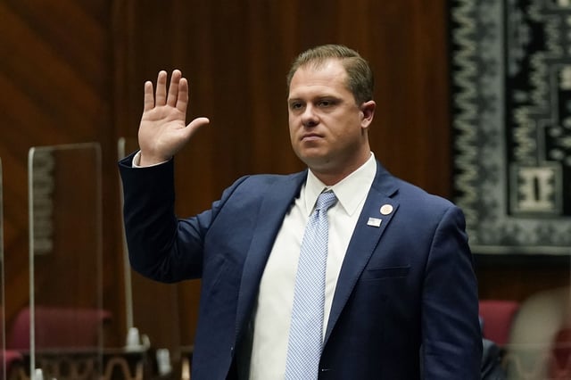 FILE - Arizona Rep. Jake Hoffman, R-Queen Creek, is sworn in during the opening of the Legislature at the state Capitol,  Jan. 11, 2021, in Phoenix. Hoffman is one of 11 Republicans in Arizona who submitted a document to Congress falsely declaring Donald Trump had beaten Joe Biden in the state during the 2020 presidential election were charged Wednesday, April 24, 2024, with conspiracy, fraud and forgery, marking the fourth state to bring charges against "fake electors." (AP Photo/Ross D. Franklin, Pool, File)