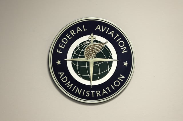 A Federal Aviation Administration sign hangs in the tower at John F. Kennedy International Airport in New York, March 16, 2017. Congressional negotiators have agreed on a $105 billion bill designed to improve the safety of air travel after a series of close calls between planes at the nation’s airports. (AP Photo/Seth Wenig, File)