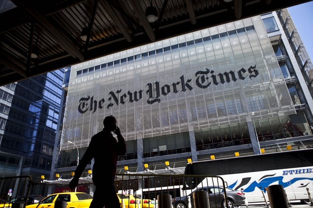 A man speaks on his mobile phone across from The New York Times headquarters building