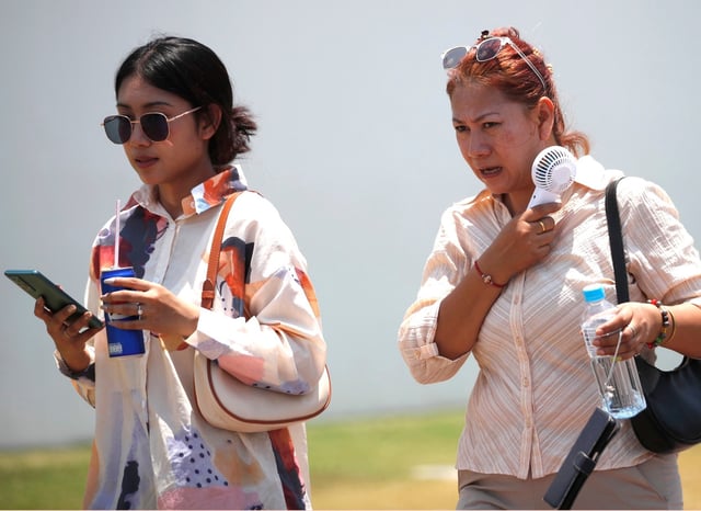 A woman uses an electric fan to cool down in Bangkok on Monday, as temperatures soared above 40 degrees Celsius. Photo: EPA-EFE