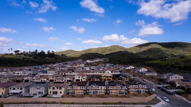 A drone view shows single-family homes at a new subdivision under construction in the rural hills of San Marcos, California, U.S., March 25, 2024.  REUTERS/Mike Blake