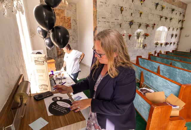 Family Service Manager Rachael Reimer with Good Shepherd Memorial Gardens in Ocala, Florida, fills out a black balloon for the Rodriguez family. Wednesday, March 6, 2024 marked Black Balloon Day. The event is to honor those who have died from drug overdoses. Drug overdose is the leading cause of accidental death in the United States. Opioid addiction is driving this epidemic. Black Balloon Day helps create awareness around the important issue of providing support to those struggling with substance use disorder and their loved ones. [Doug Engle/Ocala Star Banner]