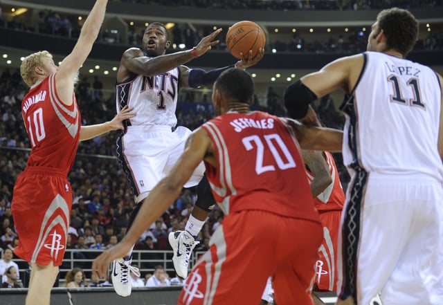 Terence Williams of the New Jersey Nets (2nd-L) scores against the Houston Rockets during the NBA China Games 2010 at the Wukesong Arena in Beijing on October 13, 2010. The Rockets and Nets will play two exhibition games in China in Beijing and Guangzhou International Sports Arena on October 16. AFP PHOTO/Peter PARKS (Photo credit should read PETER PARKS/AFP via Getty Images)