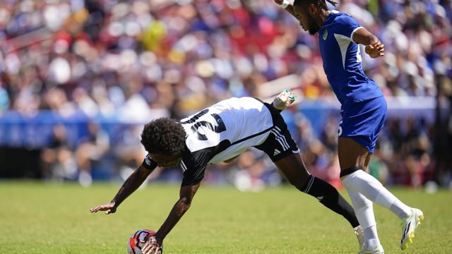Fulham's William, left, is fouled by Chelsea's Christopher Nkunku during a Premier League Summer Series soccer match, Sunday, July 30, 2023, in Landover, Md. (AP Photo/Julio Cortez)