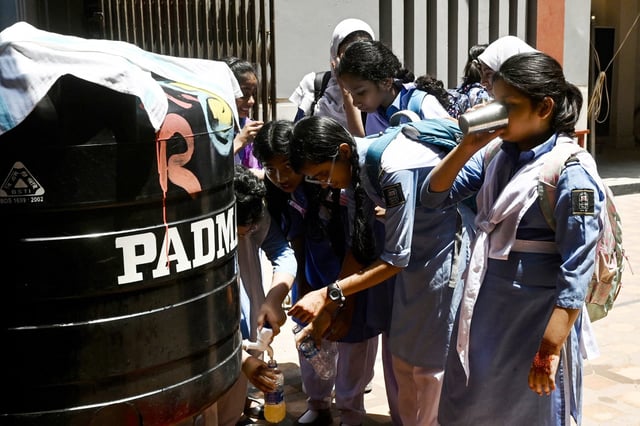 Students hydrate at a school in Dhaka, Bangladesh during a heatwave on April 28, 2024.
