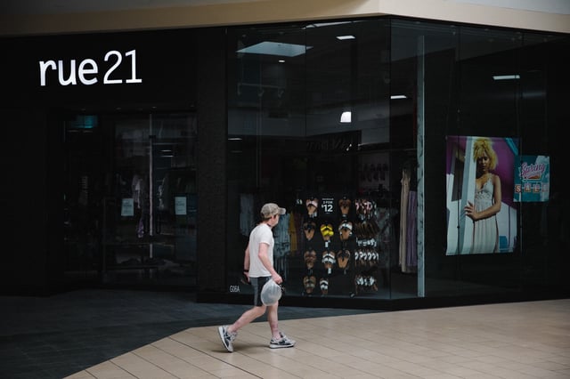 A shopper walks past a closed Rue 21 store in the re-opened Anderson Mall in Anderson, South Carolina, on Friday, April 24, 2020. After rescinding an April 3 executive order, Governor Henry McMaster set the stage for clothing, department, furniture, jewelry and sporting goods stores to reopen their doors to customers.