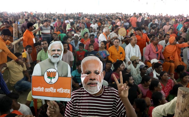 Supporters cheer with a paper mask of Indian Prime Minister Narendra Modi during a campaign in the 2024 election at Krishnanagar town, north of Kolkata. Photo: EPA-EFE
