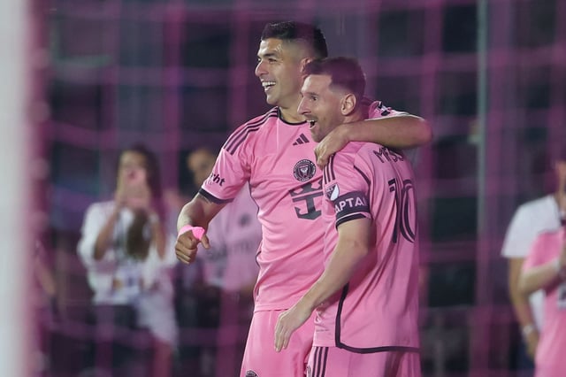 Lionel Messi celebrates with Luis Suárez.