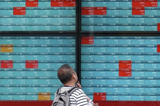 A person looks at an electronic stock board showing Japan's Nikkei 225 index at a securities firm in Tokyo, on April 16, 2024. Asian shares were mostly higher on Monday, May 6, 2024 after Wall Street ended last week with the stock market's best day in over two months in a rally backed by the cooler-than-expected U.S. employment data. (AP Photo/Eugene Hoshiko, File)
