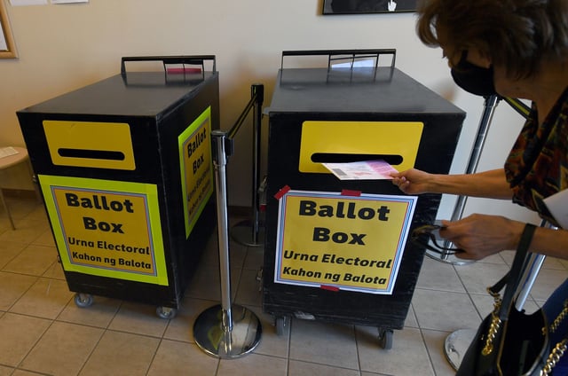 A voter puts a mail-in ballot in a ballot box at the Clark County Election Department, which serves as a drive-up and walk-up election ballot drop-off point on October 13, 2020, in North Las Vegas, Nevada.