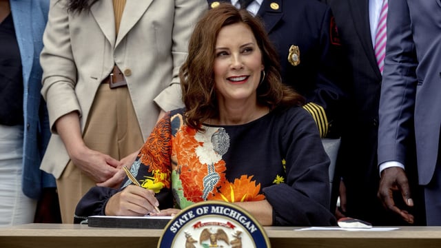 FILE - Gov. Gretchen Whitmer signs the largest state budget in Michigan's history on July 31, 2023, at the Wyandotte Fire Department, in Wyandotte, Mich. The mother of a Michigan man accused of making death threats on social media against Democratic politicians, including Whitmer, is now facing federal charges, according to an indictment unsealed Tuesday, Aug. 8, accusing her of lying when she purchased firearms that were later found in her son's possession. (Jake May/MLive.com/The Flint Journal via AP, File)