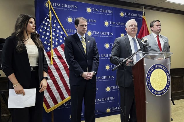 Arkansas Attorney General Tim Griffin speaks at a news conference in Little Rock on May 7, 2024, about a lawsuit challenging a new regulation aimed at protecting the rights of transgender students in schools. Missouri Attorney General Andrew Bailey, right, and Arkansas Solicitor General Nicholas Bronni and high school athlete Amelia Ford, left, listen. 