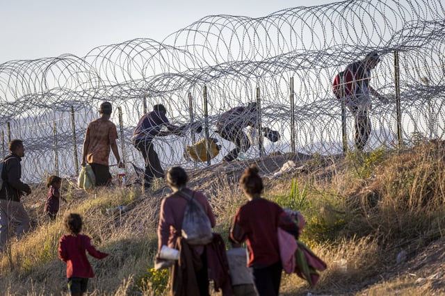 Migrants cross into the United States from Mexico on May 8, 2023 in El Paso, Texas.