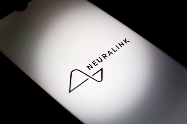 The Neuralink logo on a smartphone screen.