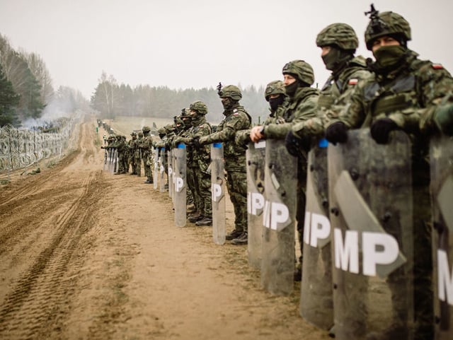 KUZNICA, POLAND - NOVEMBER 11: In this handout image issued by the Polish Ministry of National Defence, soldiers from the Polish Armed Forces patrol the Belarus-Polish border on November 11, 2021 in Kuznica, Poland. The situation on the border between Poland and Belarus continues to intensify, as hundreds of migrants arrive at the Polish border to join the EU. (Photo by Irek Dorozanski/Polish Ministry of National Defence via Getty Images)