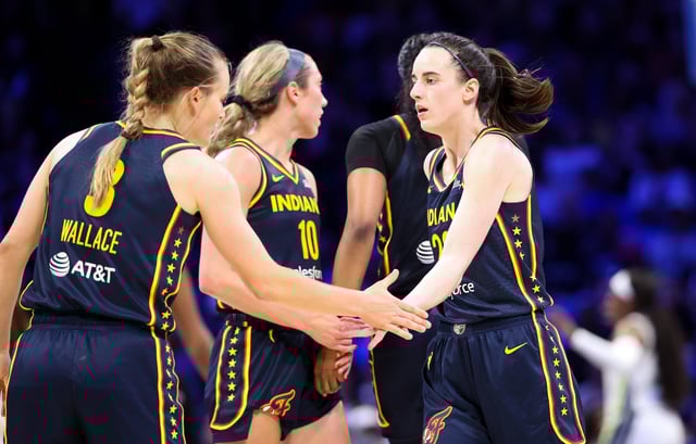 Indiana Fever guard Caitlin Clark (22) celebrates with Indiana Fever guard Kristy Wallace (3) during a preseason game against the Dallas Wings on May 3.