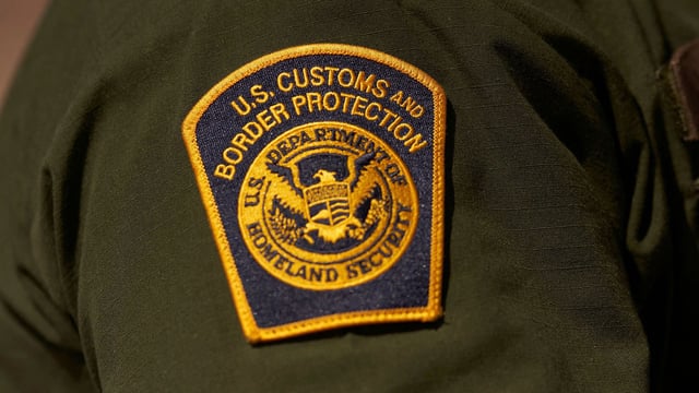 A US Customs and Border Protection patch is seen on the arm of an agent in the Jacumba mountains on October 6, 2022 in Imperial County, California. - In the fiscal year 2022 the number of migrant apprehensions exceeded 2 million, a new record in US Border Patrol history, but these apprehensions include many repeat offenders. (Photo by allison dinner / AFP) (Photo by ALLISON DINNER/AFP via Getty Images)