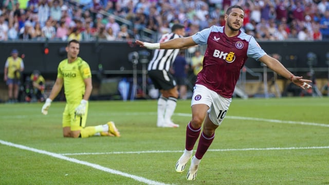 Aston Villa's Emiliano Buendía, right, reacts after his goal against Newcastle United's Martin Dubravka, left, during the first half of an English Premier League Summer Series soccer match, Sunday, July 23, 2023 in Philadelphia. (AP Photo/Chris Szagola)