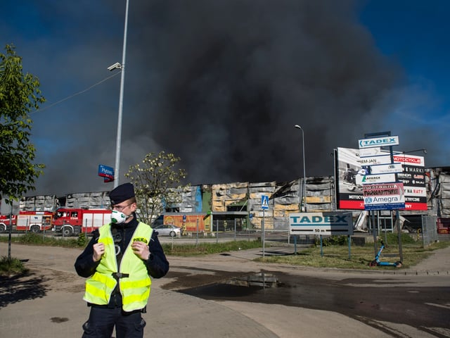 WARSAW, MASOVIAN VOIVODESHIP, POLAND - 2024/05/12: Black smoke seen in the sky above the burning Marywilska 44 shopping center in Warsaw. A massive fire broke out at the Marywilska 44 shopping center in Warsaw's Biaoleka district. According to the State Fire Service, there are 50 fire brigades on site, with a total of nearly 300 firefighters working there, including from the chemical unit. Water is drawn from a nearby canal to extinguish the fire. About 1400 shops are completely burnt down so far. Residents of Warsaw and the surrounding area received a government security center alert, urging them to stay at home and close their windows. (Photo by Attila Husejnow/SOPA Images/LightRocket via Getty Images)
