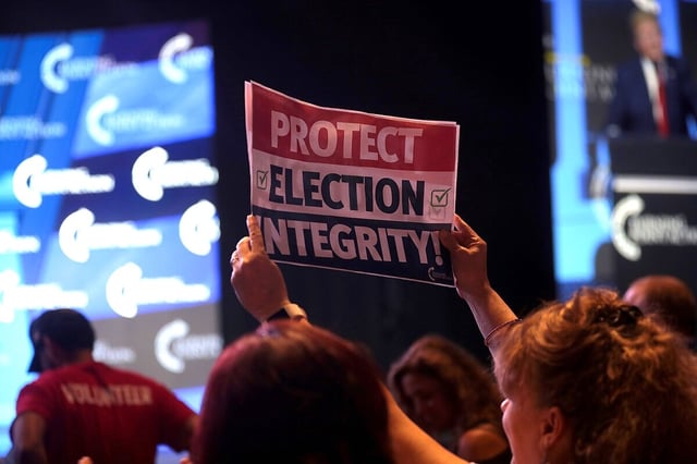 Someone holding an 'election integrity' sign.