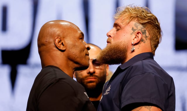 Mike Tyson and Jake Paul meet onstage at a press conference promoting their upcoming boxing match.